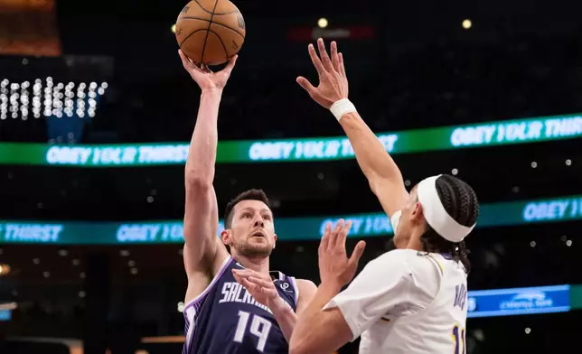Sacramento Kings forward Drew Eubanks, left, shoots as Los Angeles Lakers center Jaxson Hayes defends during the first half of an NBA basketball game in Los Angeles, Sunday, March 1, 2026. (AP Photo/Kyusung Gong)