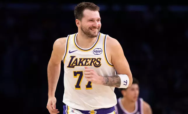 Los Angeles Lakers guard Luka Doncic smiles during the first half of an NBA basketball game against the Sacramento Kings in Los Angeles, Sunday, March 1, 2026. (AP Photo/Kyusung Gong)