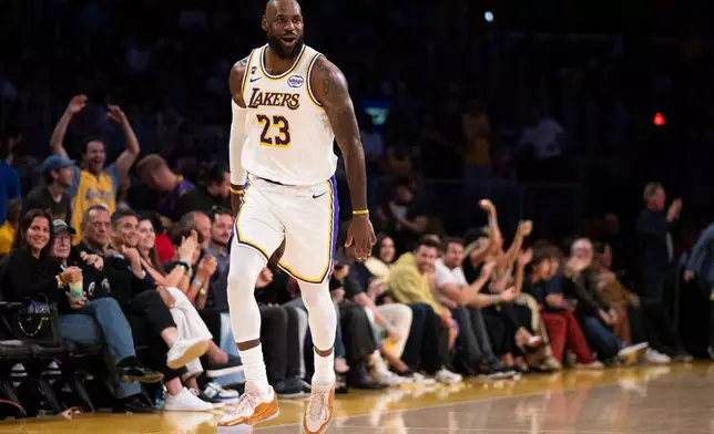 Los Angeles Lakers forward LeBron James reacts after scoring a basket during the first half of an NBA basketball game against the Sacramento Kings in Los Angeles, Sunday, March 1, 2026. (AP Photo/Kyusung Gong)