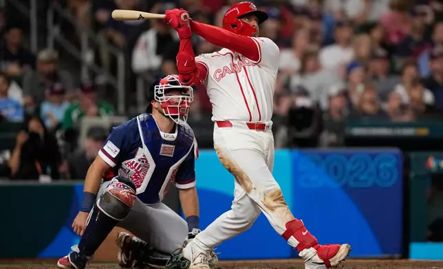 Canada catcher Bo Naylor, hits a two-run homer against the United States during the sixth inning of a World Baseball Classic quarterfinal game, Friday, March 13, 2026, in Houston. (AP Photo/David J. Phillip)