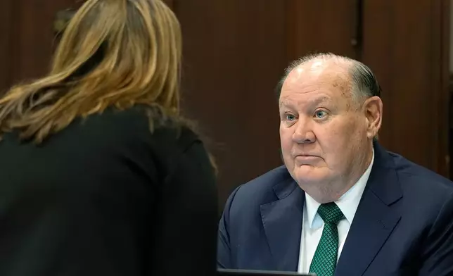 Defense attorney Rachael Israel talks chats with former FirstEnergy CEO Chuck Jones before the start of closing arguments in his trial in Summit County Common Pleas Judge Susan Baker Ross's courtroom in Akron on Tuesday, March 17, 2026. (Mike Cardew/Akron Beacon Journal via AP, Pool)