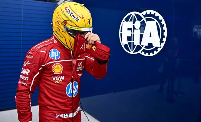 FILE - Ferrari driver Lewis Hamilton of Britain walks back to his pits during the qualifying session for the Hungarian Formula One Grand Prix at the Hungaroring racetrack in Mogyorod, Hungary, Aug. 2, 2025. (AP Photo/Denes Erdos, file)