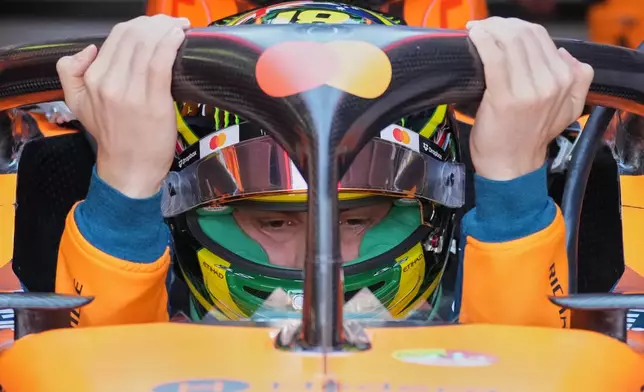 McLaren driver Oscar Piastri of Australia gets into his car for the first practice session for the Australian Formula One Grand Prix at Albert Park, in Melbourne, Australia, Friday, March 6, 2026. (AP Photo/Asanka Brendon Ratnayake)