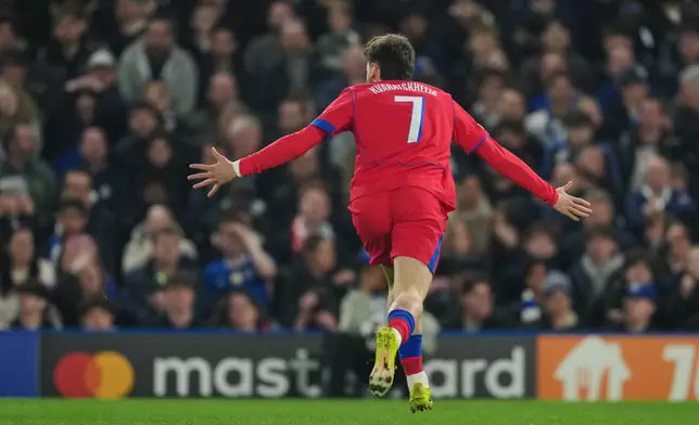 PSG's Khvicha Kvaratskhelia celebrates after scoring his side's opening goal during the Champions League soccer match between Chelsea and Paris Saint-Germain in London, England, Tuesday, March 17, 2026. (AP Photo/Kin Cheung)