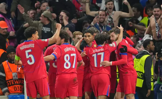 Paris Saint-Germain players celebrate after PSG's Bradley Barcola scored his side's second goal during the Champions League soccer match between Chelsea and Paris Saint-Germain in London, England, Tuesday, March 17, 2026. (AP Photo/Kin Cheung)