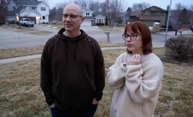 Andrew Coady and his daughter Keira, right, talk about his son, Sgt. Declan Coady, 20, of West Des Moines, Iowa, outside their home, Tuesday, March 3, 2026, in West Des Moines, Iowa. (AP Photo/Charlie Neibergall)