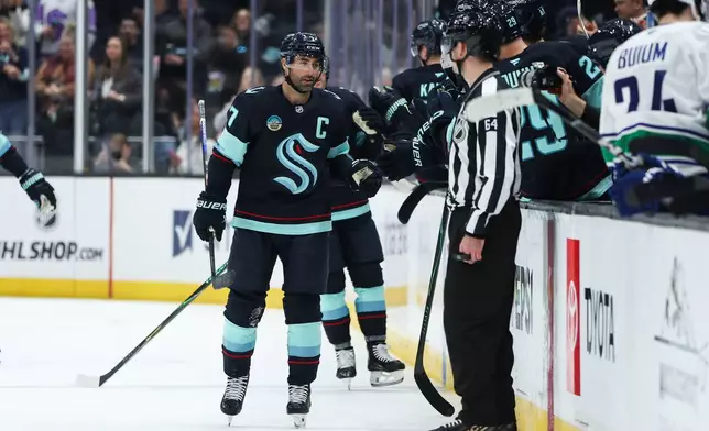 Seattle Kraken right wing Jordan Eberle (7) celebrates a goal with the bench in the second period against the Vancouver Canucks during an NHL hockey game Saturday, Feb. 28, 2026, in Seattle. (AP Photo/Kevin Ng)