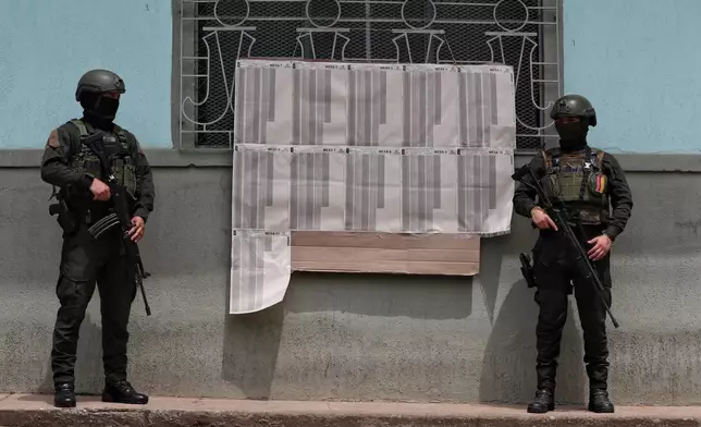 Police guard a polling station in Buenos Aires, Cauca state, Colombia, Sunday, March 8, 2026. (AP Photo/Santiago Saldarriaga)