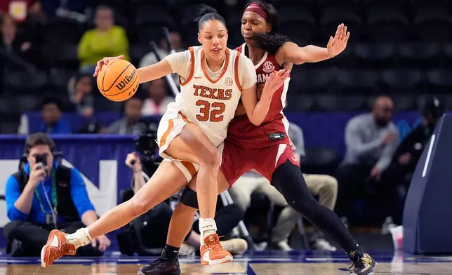 Texas forward Teya Sidberry drives to the basket past Alabama guard Jessica Timmons during first half of an NCAA college basketball game in the quarterfinals of the Southeastern Conference tournament, Friday, March 6, 2026, in Greenville, S.C. (AP Photo/Chris Carlson)