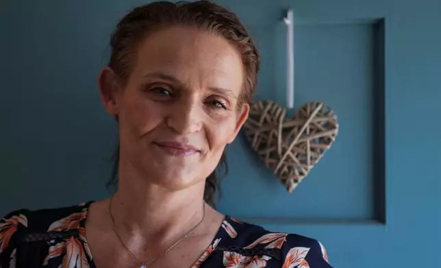 Jessica Thompson, 47, sits for a portrait at her Rockford, Ill., home on Saturday, March 21, 2026. (AP Photo/Erin Hooley)