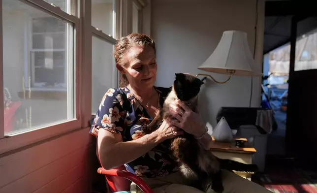 Jessica Thompson, 47, sits for a portrait at her Rockford, Ill., home on Saturday, March 21, 2026. (AP Photo/Erin Hooley)