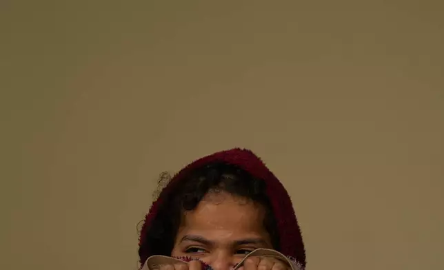 A girl displaced by Israeli airstrikes, looks on at a school used as a shelter in Beirut, Lebanon, Monday, March 9, 2026. (AP Photo/Hassan Ammar)