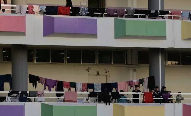 Displaced people fleeing Israeli airstrikes in southern Lebanon and Dahiyeh, Beirut's southern suburbs, settle at a school turned into a shelter in Beirut, Lebanon, Thursday, March 5, 2026. (AP Photo/Bilal Hussein)