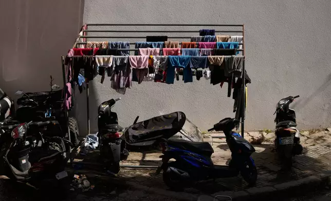 Clothes hang to dry outside a school in Beirut, used as a shelter for people displaced by Israeli airstrikes in southern Lebanon and Dahiyeh, Beirut's southern suburbs, Monday, March 9, 2026. (AP Photo/Hassan Ammar)
