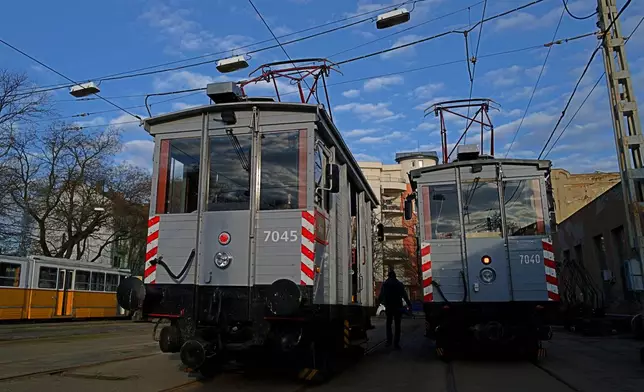 Two century-old freight trams are parked in the Kelenfold tram depot in Budapest, Hungary on Thursday, March 12, 2026. (AP Photo/Bela Szandelszky)