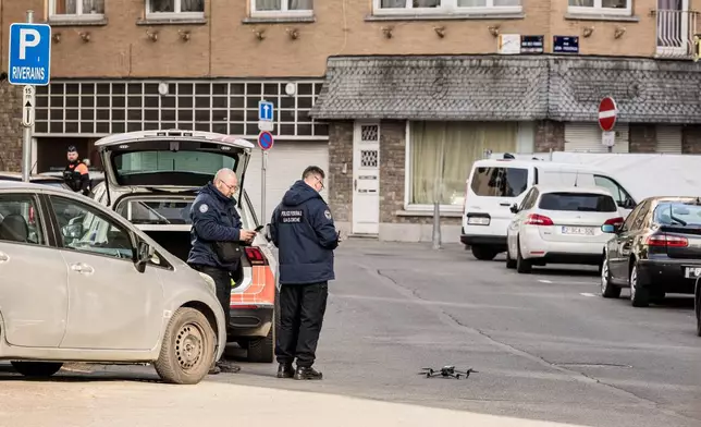 Police prepare to fly a drone in a secure area after a blast took place near a synagogue, in Liege, Belgium, Monday, March 9, 2026. (AP Photo/Valentin Bianchi)