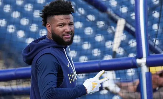 FILE - Milwaukee Brewers' Jackson Chourio gestures during a spring training baseball workout, Feb. 18, 2026, in Phoenix. (AP Photo/Morry Gash, File)