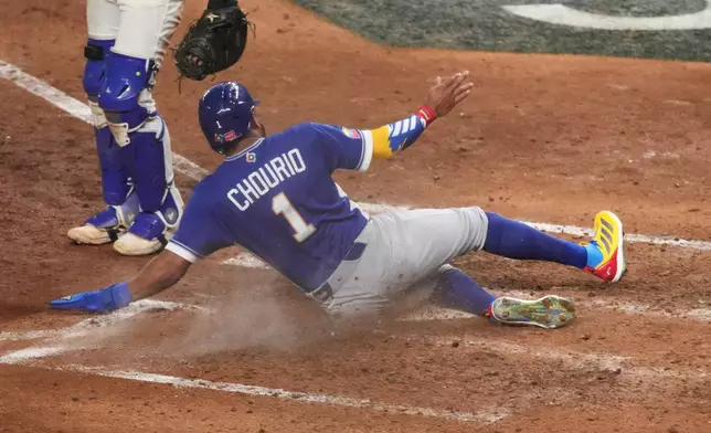 Venezuela Jackson Chourio (1) scores during the seventh inning of a World Baseball Classic semifinal game against Italy, Monday, March 16, 2026, in Miami. (AP Photo/Lynne Sladky)