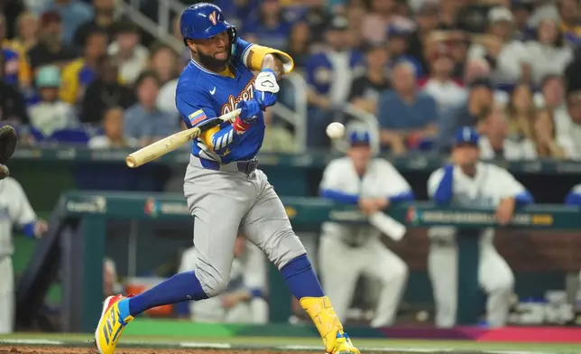 Venezuela Jackson Chourio hits a single during the seventh inning of a World Baseball Classic semifinal game against Italy, Monday, March 16, 2026, in Miami. (AP Photo/Rebecca Blackwell)