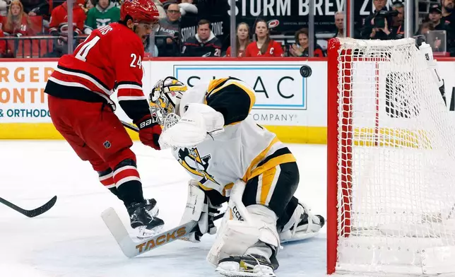 Carolina Hurricanes' Seth Jarvis (24) beats Pittsburgh Penguins goaltender Stuart Skinner (74) but misses the net during the second period of an NHL hockey game in Raleigh, N.C., Wednesday, March 18, 2026. (AP Photo/Karl DeBlaker)