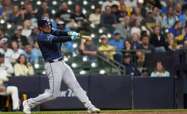 Tampa Bay Rays' Nick Fortes hits an RBI double during the ninth inning of a baseball game against the Milwaukee Brewers, Monday, March 30, 2026, in Milwaukee. (AP Photo/Aaron Gash)