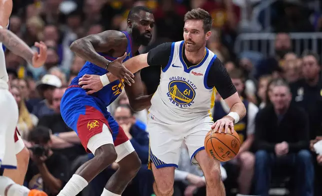 Golden State Warriors guard Pat Spencer, right, drives past Denver Nuggets guard Tim Hardaway Jr. in the first half of an NBA basketball game Sunday, March 29, 2026, in Denver. (AP Photo/David Zalubowski)