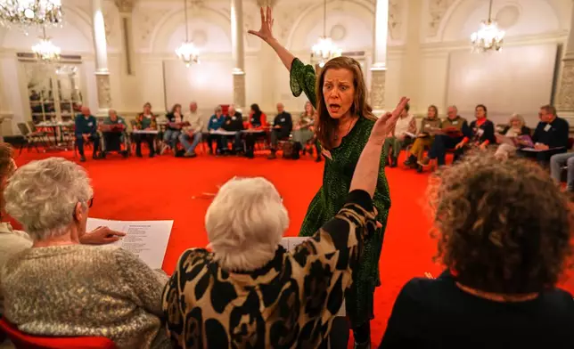 People many of them seniors with a form of dementia, join in the "singing circle" run by opera singer Maartje de Lint at the Concertgebouw's ornate Mirror Hall in Amsterdam, on Feb. 24, 2026. (AP Photo/Peter Dejong)