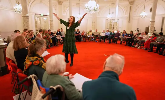 People, many of them seniors with a form of dementia, join in the "singing circle" run by opera singer Maartje de Lint, at the Concertgebouw's ornate Mirror Hall in Amsterdam on Feb. 24, 2026. (AP Photo/Peter Dejong)
