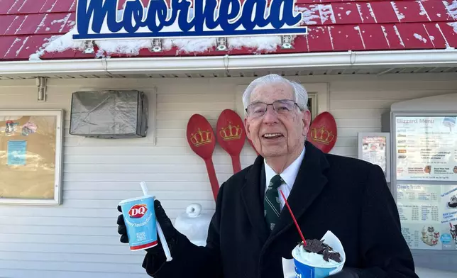 Jerry Protextor heads to his car with ice cream treats for his wife and him Sunday, March 1, 2026, at the Dairy Queen in Moorhead, Minn. (AP Photo/Jack Dura)