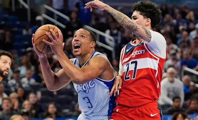 Orlando Magic guard Desmond Bane (3) goes past Washington Wizards guard Will Riley (27) for a shot during the second half of an NBA basketball game, Thursday, March 12, 2026, in Orlando, Fla. (AP Photo/John Raoux)