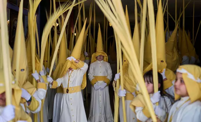 Penitents of the "Pollinita" brotherhodod take part in a Holy Week procession in Cabra, southern Spain, Sunday, March 29, 2026. (AP Photo/Manu Fernandez)