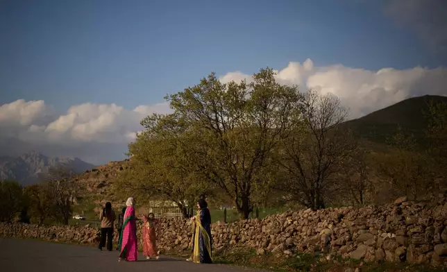 Wearing traditional clothes young women take part in a family gathering at the village of Gulp, Iraq, Tuesday, March 17, 2026. (AP Photo/Leo Correa)