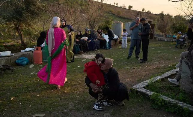 People take part in a family gathering to break the fast with an Iftar meal during the Muslim holy month of Ramadan in the village of Gulp, Iraq, Tuesday, March 17, 2026. (AP Photo/Leo Correa)