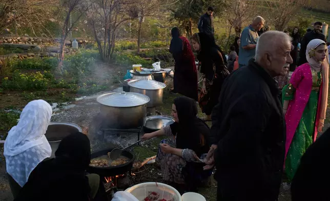 Women prepare Iftar meal as they take part in a family gathering during the Muslim holy month of Ramadan in the village of Gulp, Iraq, Tuesday, March 17, 2026. (AP Photo/Leo Correa)