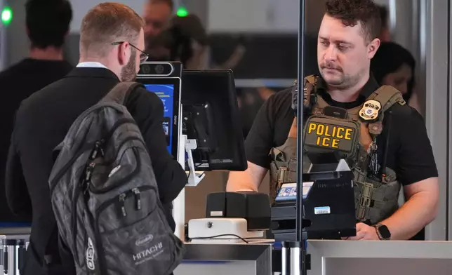 An ICE officer works at a TSA checkpoint at Pittsburgh International Airport in Imperial, Pa., on Thursday, March 26, 2026. (AP Photo/Gene J. Puskar)