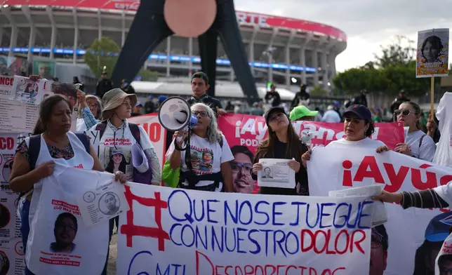 Protesters gather outside the Azteca Stadium to urge the government to help locate their missing relatives prior to the international friendly soccer match between Mexico and Portugal in Mexico City, Saturday, March 28, 2026. (AP Photo/Eduardo Verdugo)