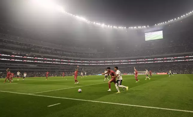 Mexico's Jesus Gallardo, right, and Portugal's Matheus Nunes compete for the ball during the international friendly soccer match between Mexico and Portugal in Mexico City, Saturday, March 28, 2026. (AP Photo/Eduardo Verdugo)