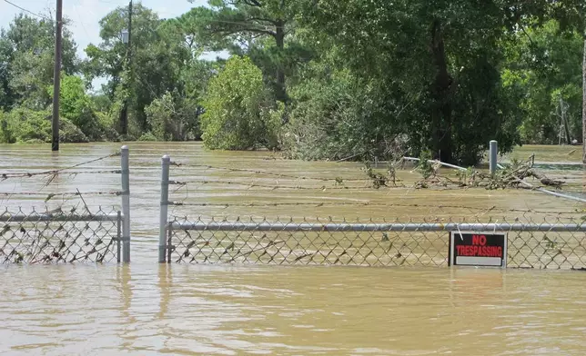 FILE - A barbed-wire fence encircles the Highlands Acid Pit that was flooded by water from the nearby San Jacinto River in the aftermath of Hurricane Harvey in Highlands, Texas on Aug. 31, 2017. (AP Photo/Jason Dearen)