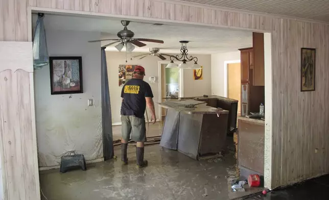 FILE - Dwight Chandler walks through his devastated home from Hurricane Harvey not too far from old acid pits that were designated as a U.S. EPA Superfund in Highlands, Texas, Aug. 31, 2017. (AP Photo/Jason Dearen, File)