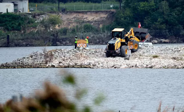 FILE - Work continues at San Jacinto River Waste Pits, a Superfund site, near the Interstate 10 bridge over the river in Channelview, Texas on Sept. 13, 2017. (AP Photo/David J. Phillip, File)