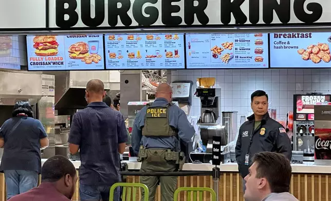 Federal immigration agents are seen at the Hartsfield-Jackson Atlanta International Airport, Monday, March 23, 2026, in Atlanta. (AP Photo/Emilie Megnien)