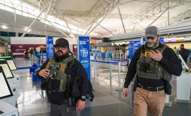 Federal immigration agents walk through Terminal 8 at John F. Kennedy International Airport (JFK) in the Queens borough of New York, Monday, March 23, 2026. (AP Photo/Ryan Murphy)