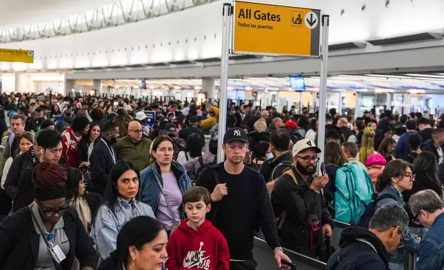 People wait in long TSA security lines at John F. Kennedy International Airport (JFK) in the Queens borough of New York, Monday, March 23, 2026. (AP Photo/Ryan Murphy)