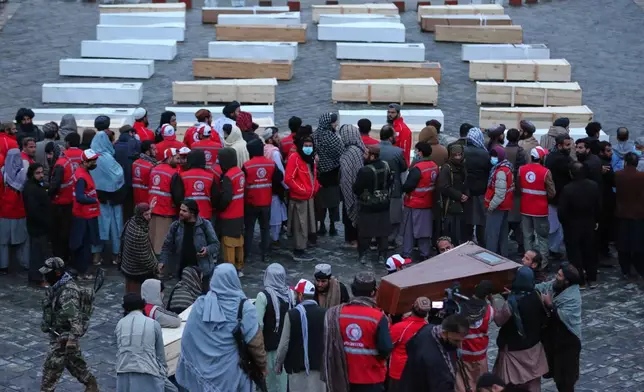 Coffins containing the remains of victims of a Monday airstrike on a drug rehabilitation hospital are laid out before burial in Kabul, Afghanistan, Wednesday, March 18, 2026. (AP Photo/Siddiqullah Alizai)