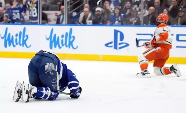 Toronto Maple Leafs Auston Matthews, left, is injured by Anaheim Ducks Radko Gudas during the second period of an NHL hockey game in Toronto, Thursday, March 12, 2026. (Nathan Denette/The Canadian Press via AP)