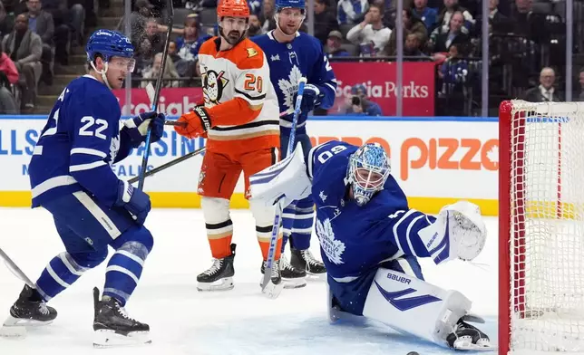 Toronto Maple Leafs goaltender Joseph Woll (60) is scored on as Jake McCabe (22), Brandon Carlo (25) and Anaheim Ducks Chris Kreider (20) watch during first period NHL hockey action in Toronto on Thursday, March 12, 2026. (Nathan Denette/The Canadian Press via AP)