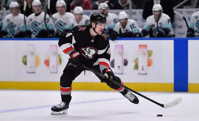 Buffalo Sabres defenseman Bowen Byram (4) skates with the puck during the first period of an NHL hockey game against the Seattle Kraken, Saturday, March 28, 2026, in Buffalo, N.Y. (AP Photo/Adrian Kraus)