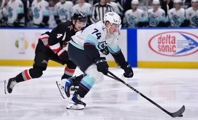 Seattle Kraken center Bobby McMann (74) skates with the puck during the second period of an NHL hockey game against the Buffalo Sabres, Saturday, March 28, 2026, in Buffalo, N.Y. (AP Photo/Adrian Kraus)
