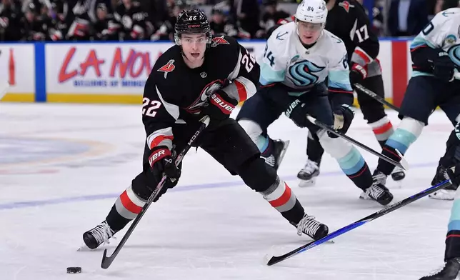 Buffalo Sabres right wing Jack Quinn (22) skates with the puck during the first period of an NHL hockey game against the Seattle Kraken, Saturday, March 28, 2026, in Buffalo, N.Y. (AP Photo/Adrian Kraus)