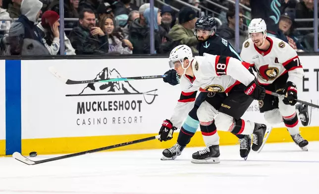 Ottawa Senators forward Tim Stutzle (18) skates against Seattle Kraken forward Matty Beniers, second from left, during the third period of an NHL hockey game Saturday, March 7, 2026, in Seattle. (AP Photo/Stephen Brashear)